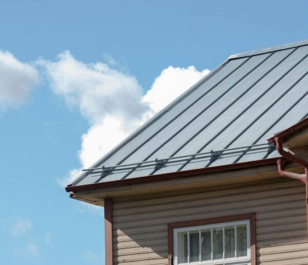 Close-up of a wooden building with metal roof and window in sunny Tartu, Estonia.